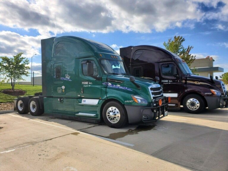 Two Prime trucks parked at an angle in a parking lot