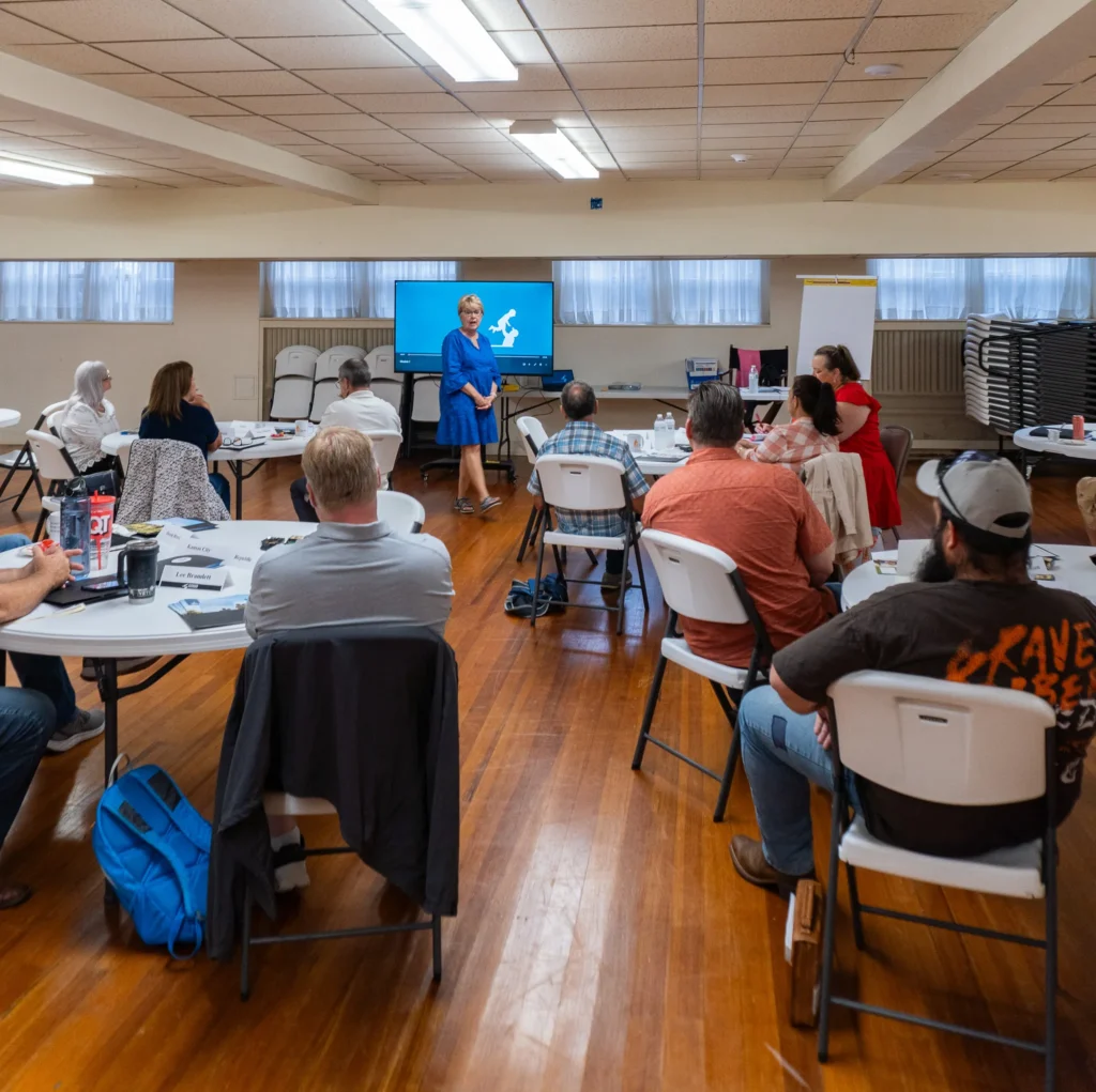 Dr. Jennifer L. Baker, Good Dads founder and executive director, speaks to a group of community leaders on Wednesday, July 17.