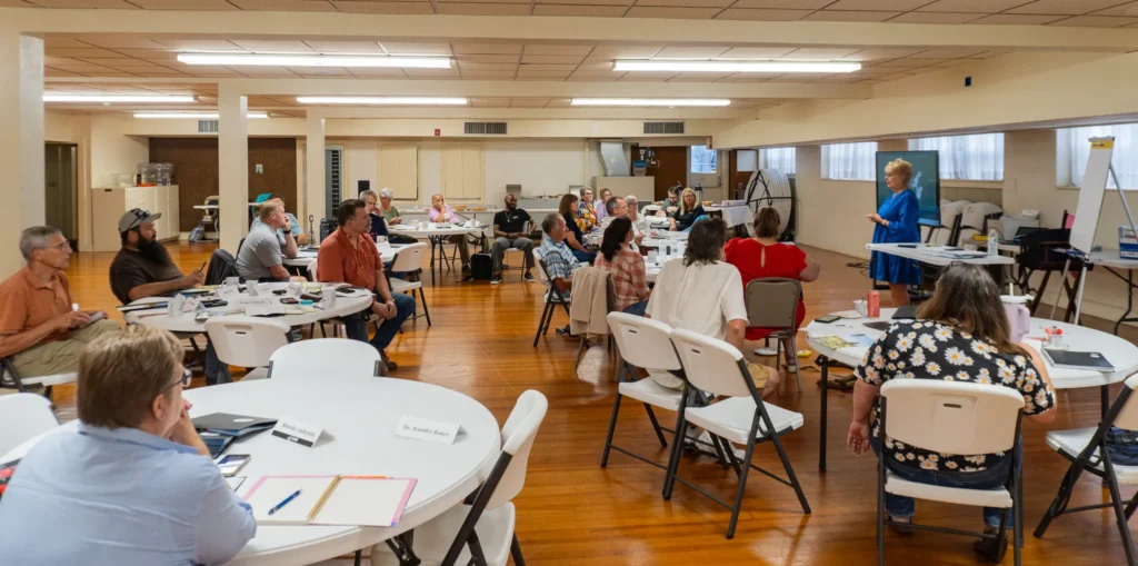 Dr. Jennifer L. Baker, Good Dads founder and executive director, speaks to a group of community leaders on Wednesday, July 17.