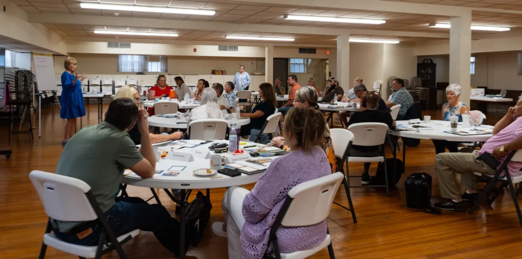 Dr. Jennifer L. Baker, Good Dads founder and executive director, speaks to a group of community leaders on Wednesday, July 17.