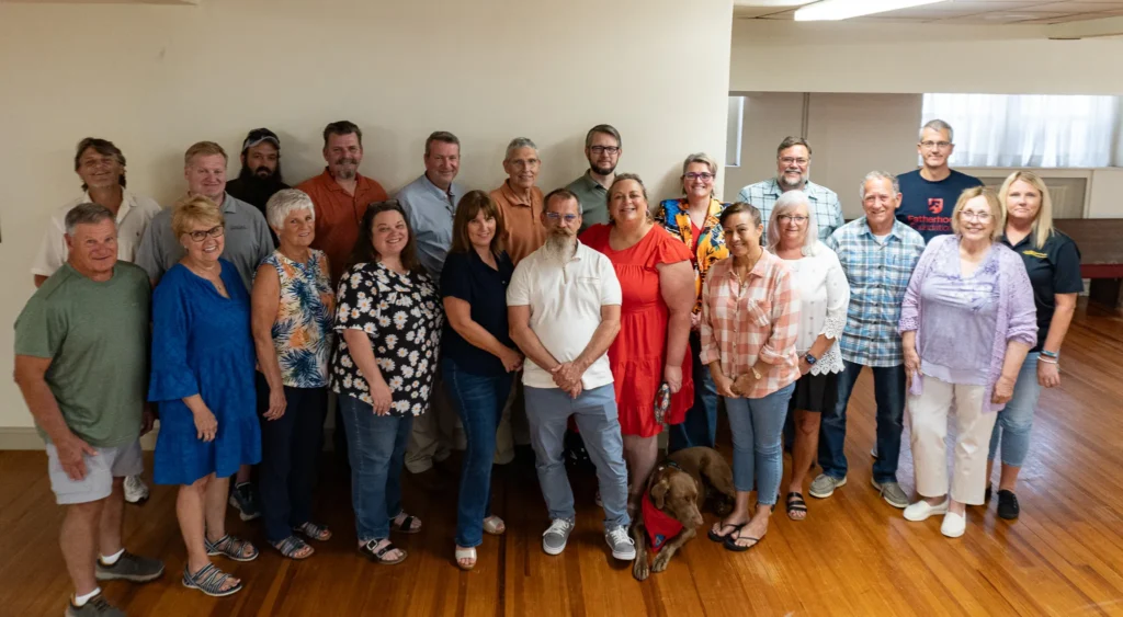 A group photo with community leaders at the Good Dads chapter meeting in July 2024.