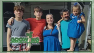 Michael, his wife, and his three children stand with their arms around each other outside of their home.