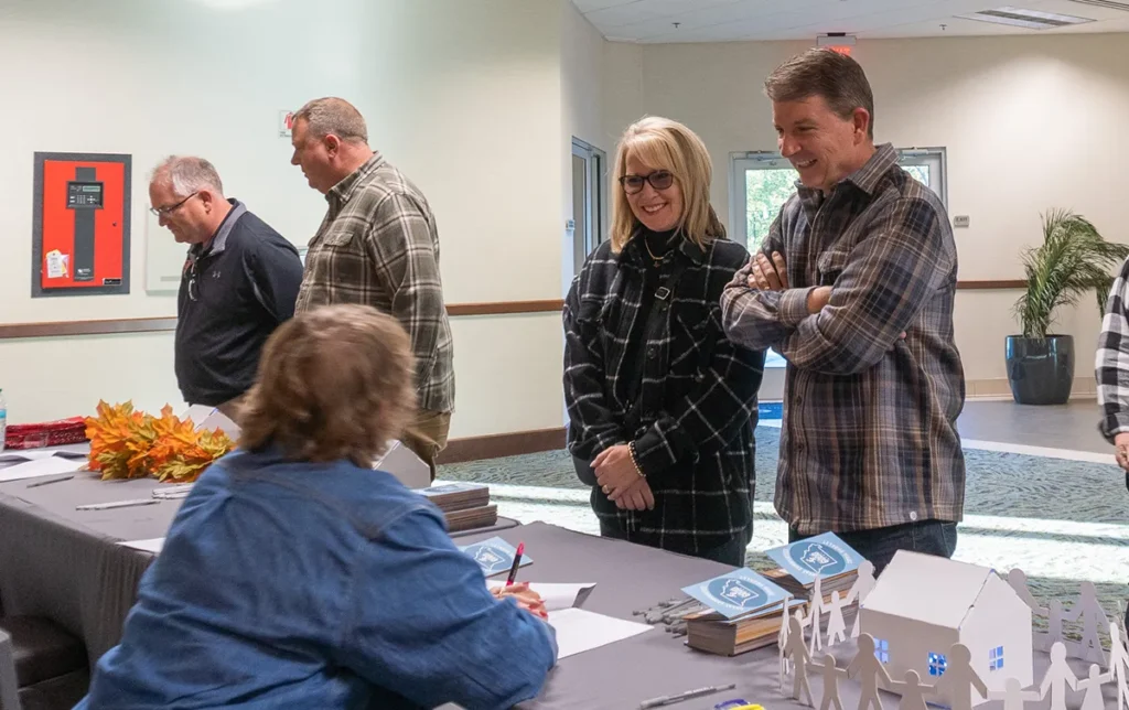 Guests smile at the check-in table at the fundraiser.