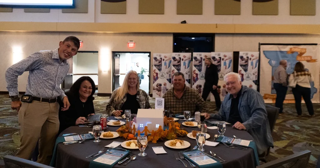 A group of happy people seated at a table.