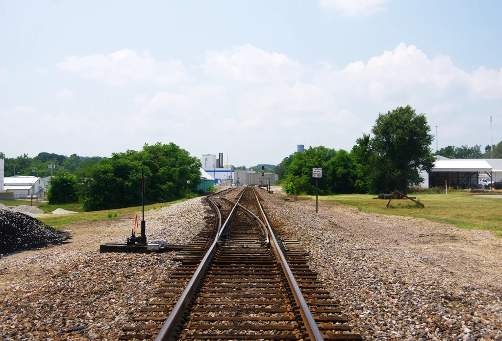 Railroad tracks under a blue sky