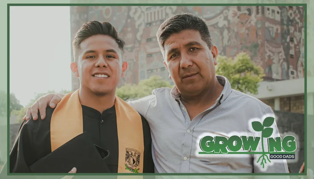 A dad wraps his arms around his son. The son wears a graduation gown.