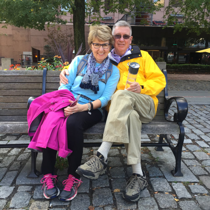 Dr. Jennifer Baker sits on a park bench next to Paul Baker