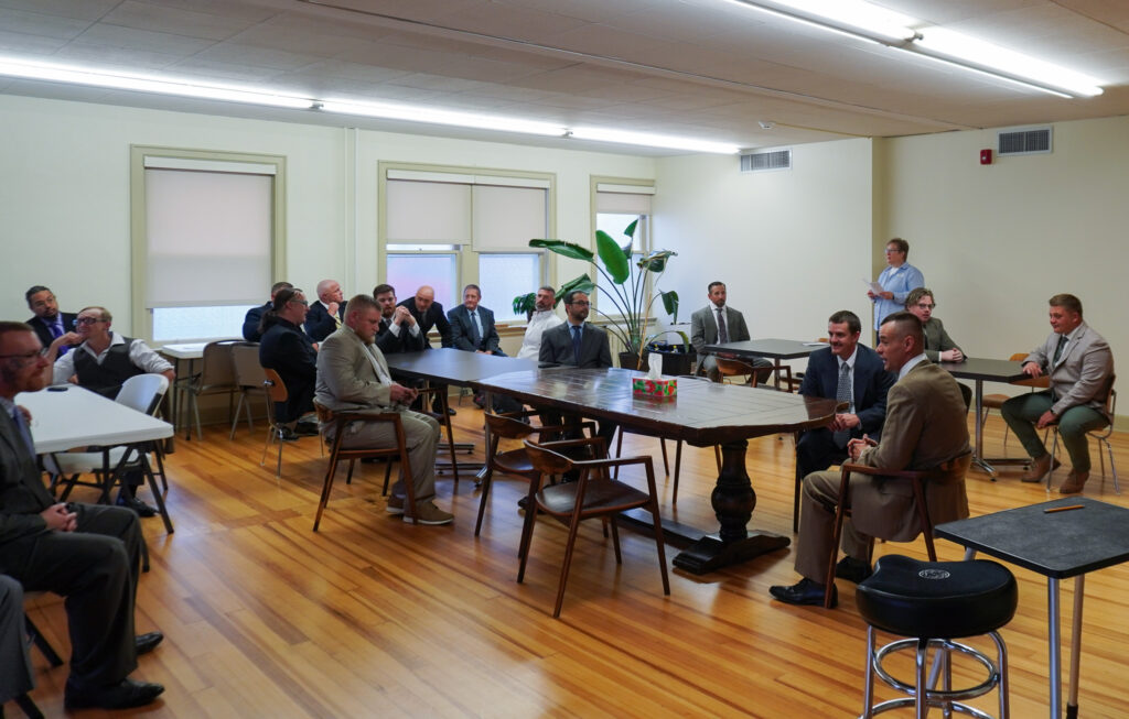 New Pathways for Good Dads graduates gather in the church's classroom space and wait for instructions before the ceremony begins.