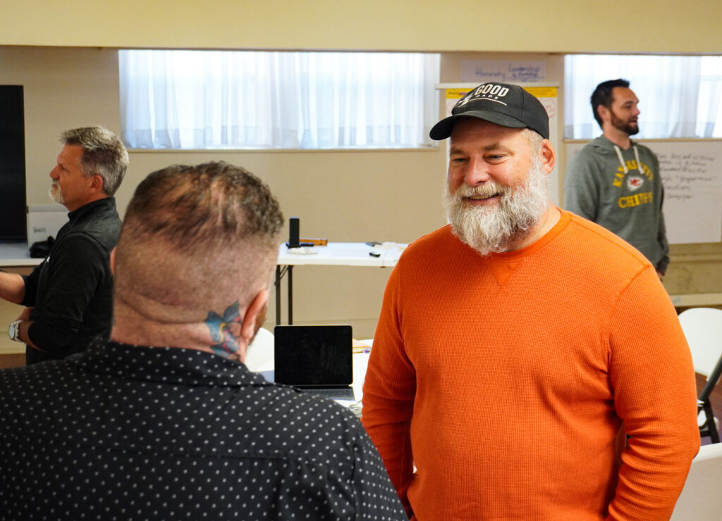 Two men speak to each other during a Good Dads training event.