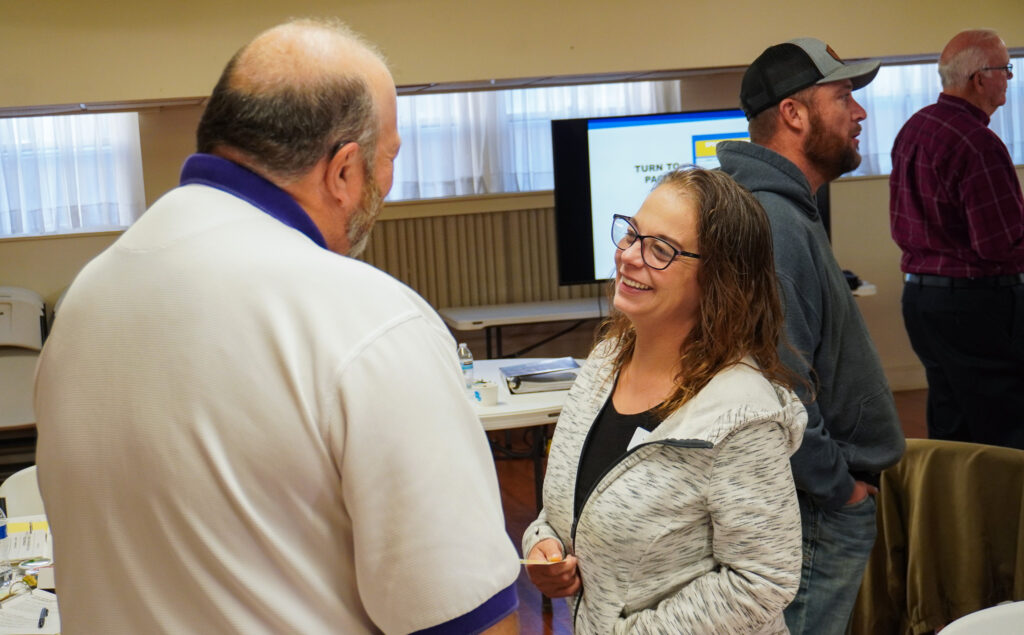 A man and a woman speaking to each other during the Good Dads training event.