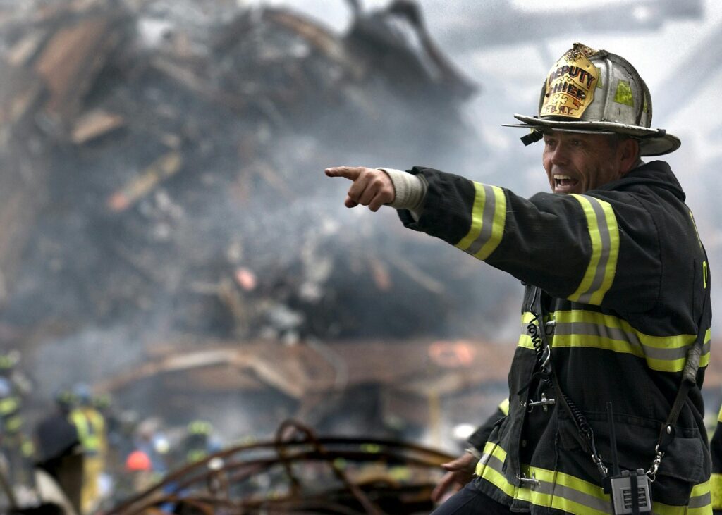 A firefighter points to an out of frame object