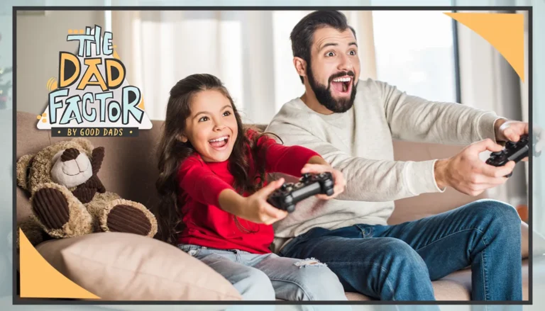 A father and daughter sit side by side on the couch playing video games