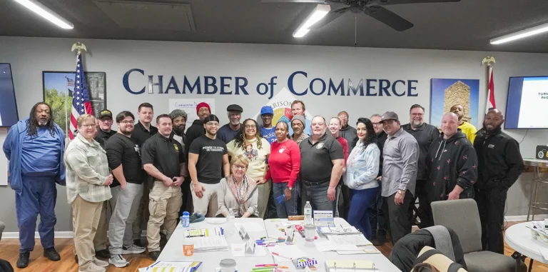 Facilitators smile for a group photo at the Harrisonville Chamber of Commerce in January 2025.