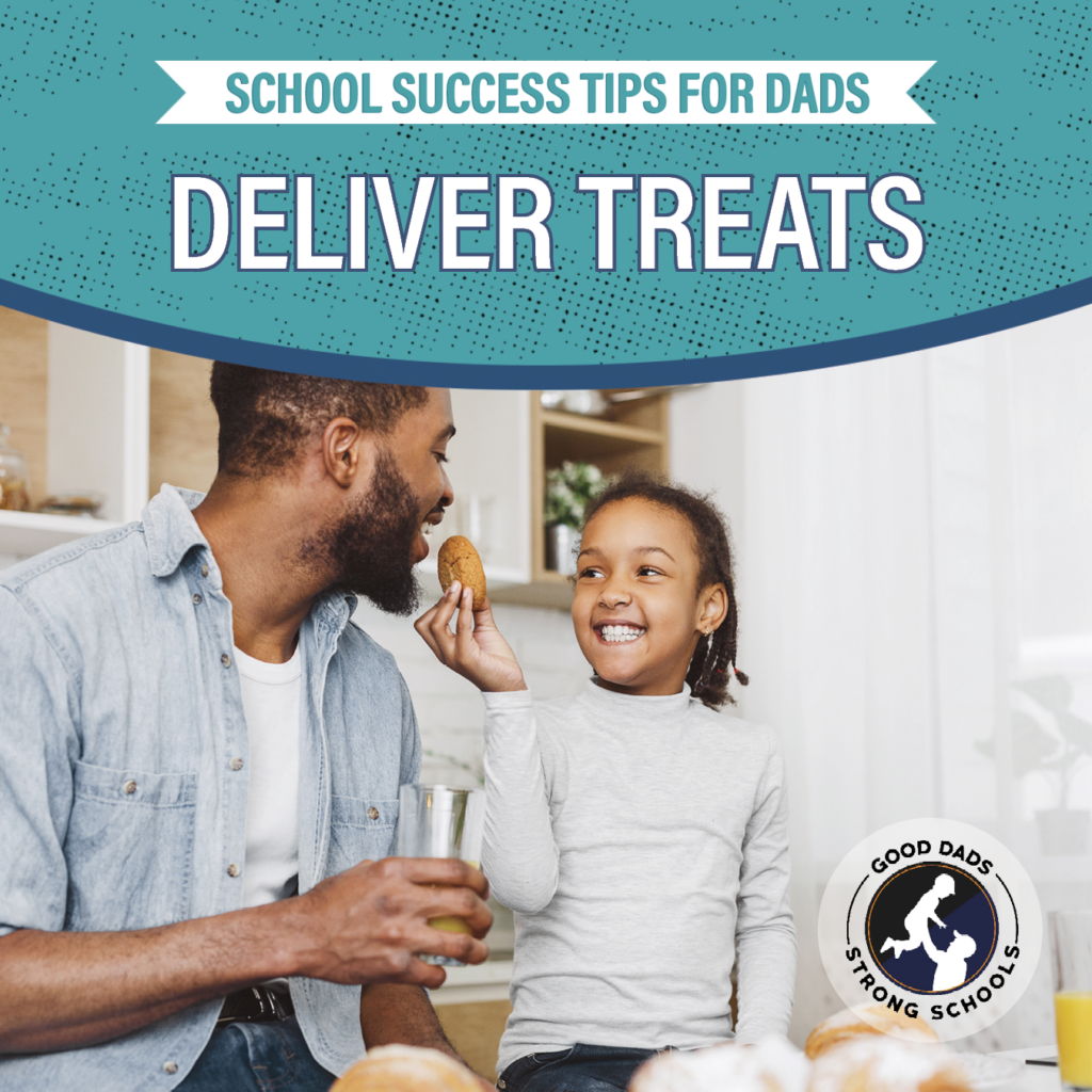 School Success Tips for Dads: deliver treats - a young girl and her dad sit in a kitchen while the daughter holds a cookie up to her smiling dad's mouth.