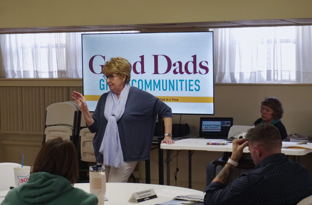 Founder and executive director Dr. Jennifer L. Baker stands at the front of the room during her presentation at the chapter orientation.
