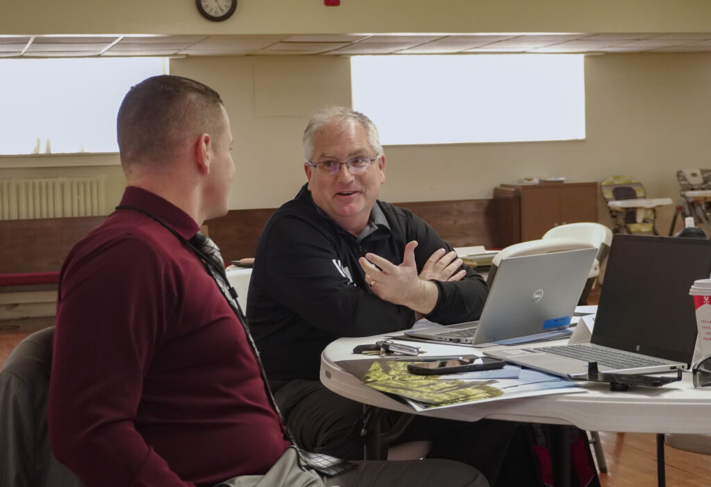 Branson educator Mike Dawson speaks to his group at his table during chapter orientation.