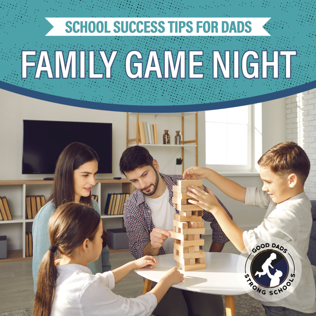 School Success Tips for Dads: Family game night - a mom, dad, son and daughter kneel around a table in a living room and play Jenga.