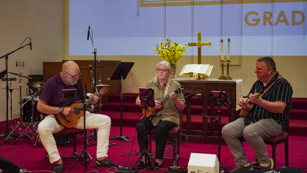 From left to right, Jesse Owsley, Karen Maxson and Rick Maxson sit on stage at the Downtown Church to play ukulele music.