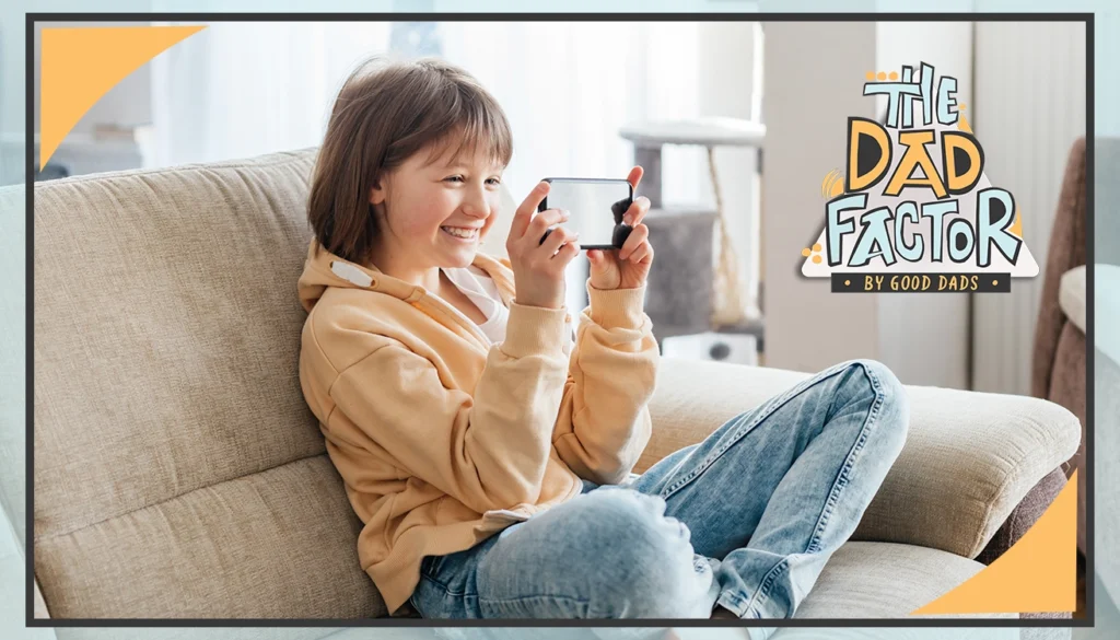 The Dad Factor: A smiling girl sits on a couch, looking at her phone
