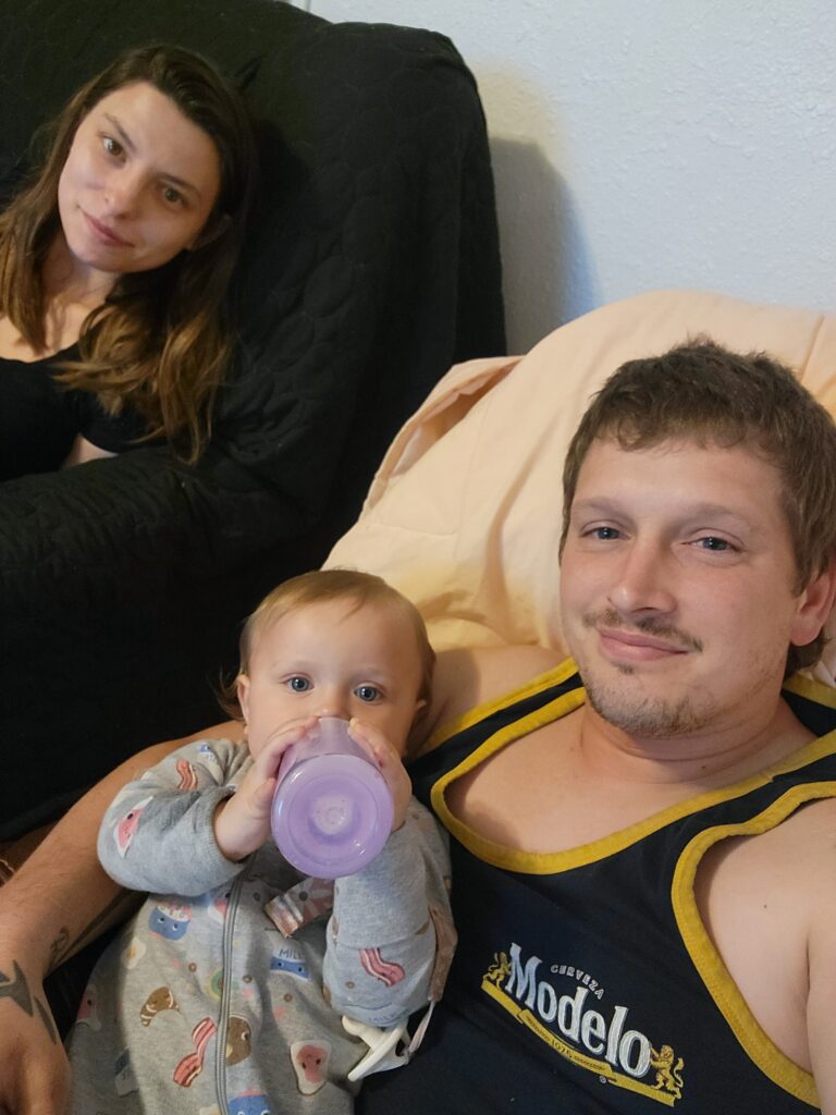 Mason Biaggi holds his baby girl Adalina next to his wife Lena