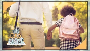 A father holds his daughter's hand. Their backs are turned to the camera, and the daughter is wearing a backpack.