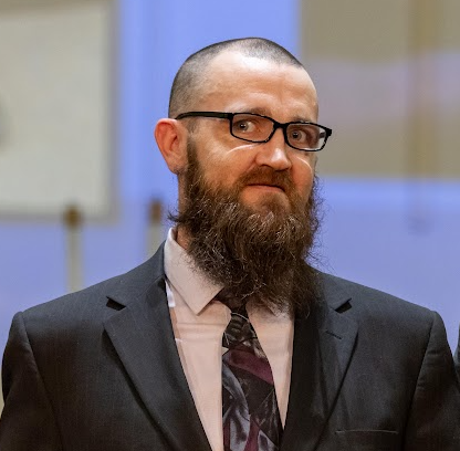 Madison Dennis in a suit at a New Pathways graduation ceremony