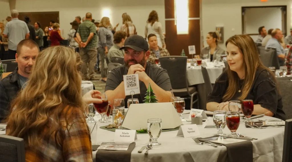 Good Dads chapter leaders from Ava, MO, happily chat at their table during cocktail hour.