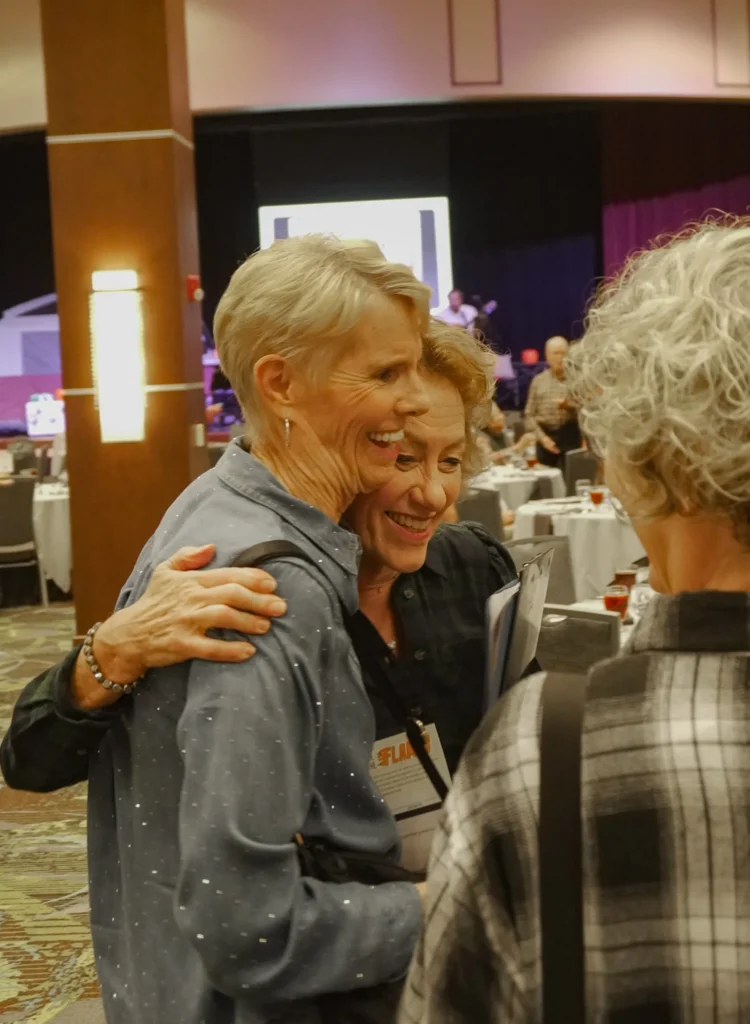 Good Dads events coordinator Terri Blackmon hugs an event attendee.