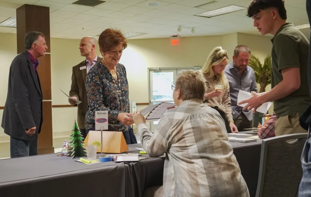 Good Dads staff work the check-in table as event guests arrive.