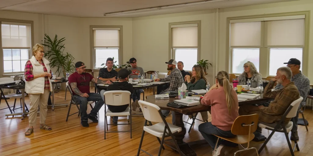 Good Dads founder and director Dr. Jennifer L. Baker stands at the front of the classroom to speak to the group of Within My Reach facilitators during Good Dads' fall Training Camp in November 2025.