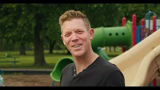 A thumbnail of a Good Dads ad: father Jeff Houghton cocks his head to the site while speaking to the camera in a park.