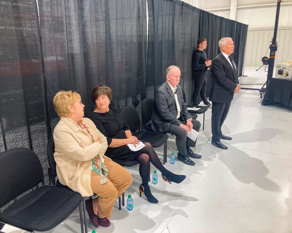 Dr. Jennifer L. Baker, founder and director of Good Dads (left), speaks with another woman back-stage
