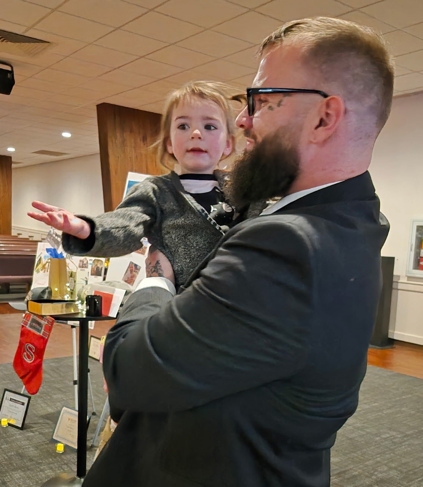 Ryan Warren holds his two-year-old daughter Samsara.