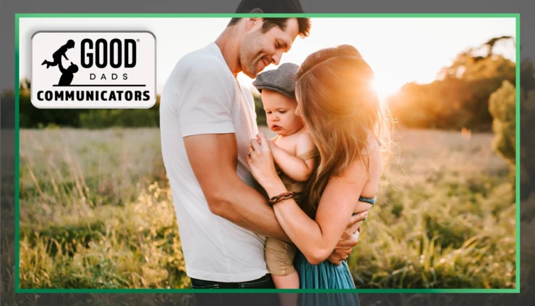 Good Dads Communicators: A father and mother hold a baby while standing in a sunny field.