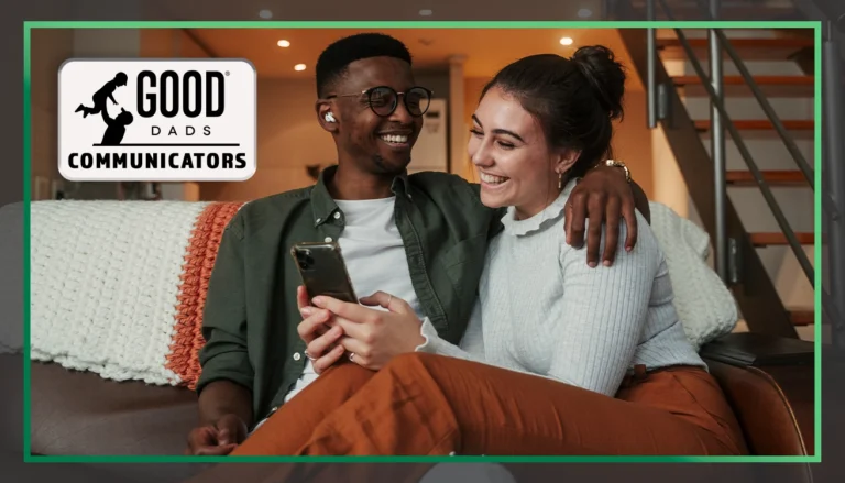 Good Dads Communicators: A man and woman sits together on a couch, smiling. The man is looking at the woman and smiling, his arm wrapped around her