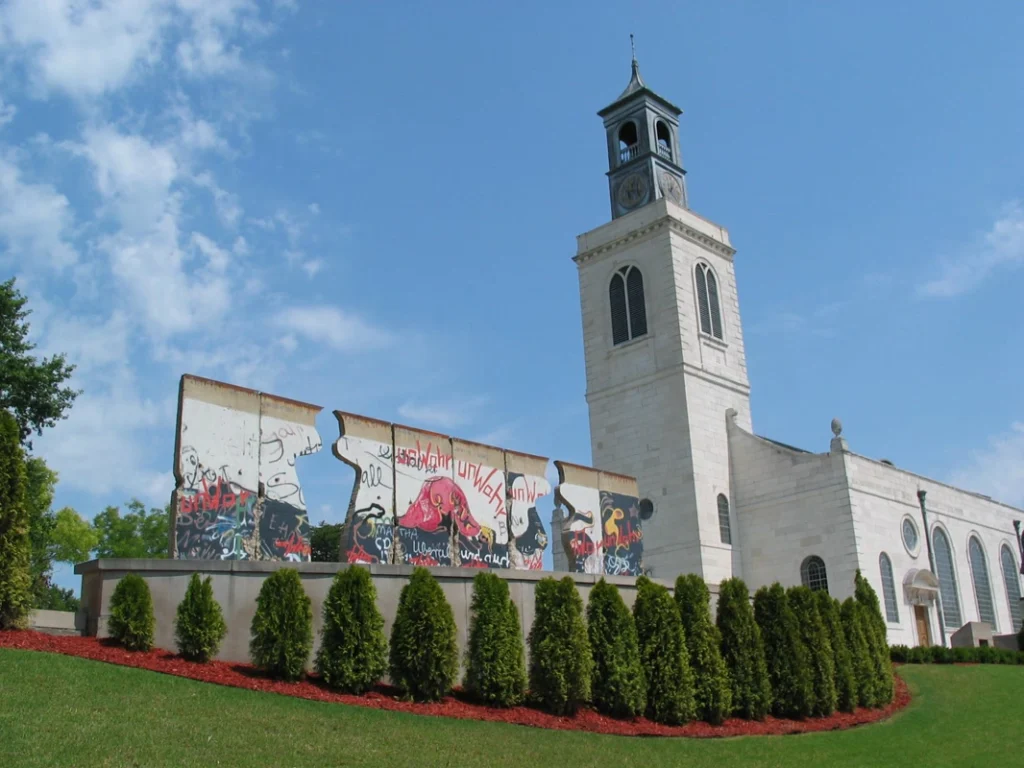 Exterior of Westminster College and America's National Churchill Museum, a white tower and mural wall in front of a bright, blue sky