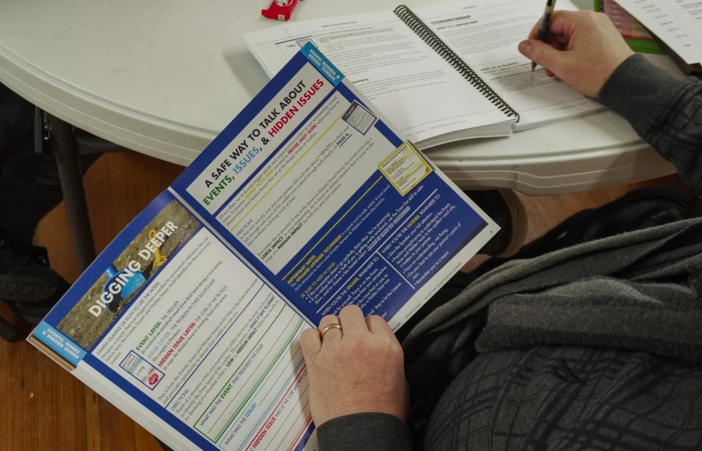 A close-up of the facilitator and participant guides for Prep 8.0 at the January 2026 Good Dads Plus Us Training Camp in Springfield MO.