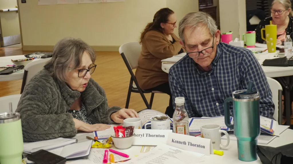 Facilitators collaborate at their chairs during the January 2026 Good Dads Plus Us Training Camp in Springfield MO.