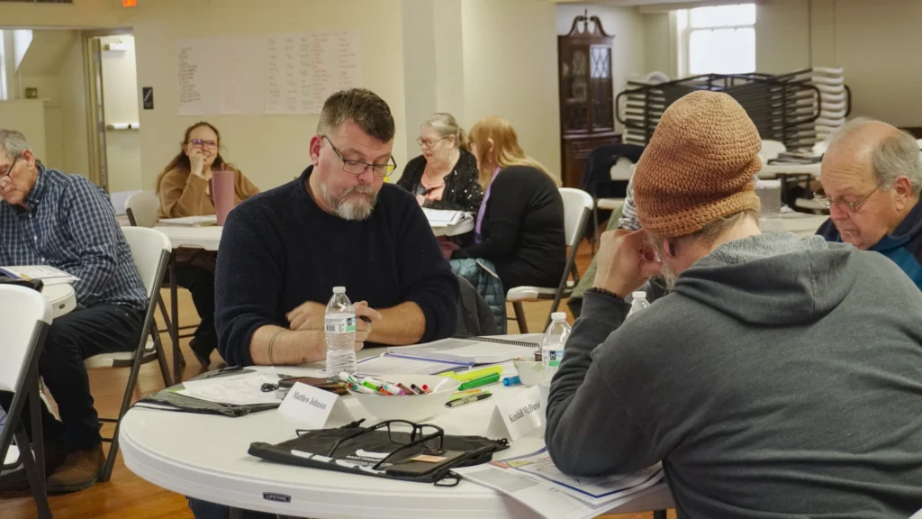 Facilitators collaborate at their chairs during the January 2026 Good Dads Plus Us Training Camp in Springfield MO.