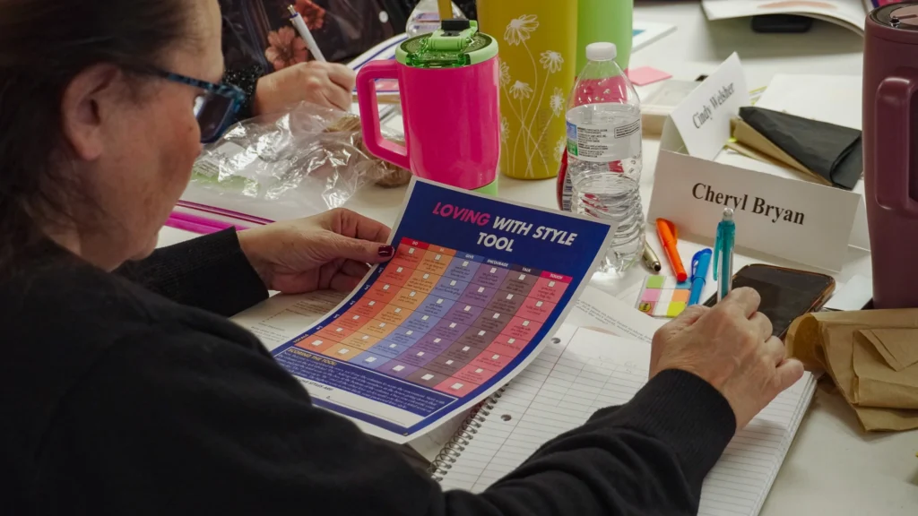 Training attendee Cheryl Bryan uses a pencil and pad of paper to rank her love style at the January 2026 Good Dads Plus Us Training Camp in Springfield MO.