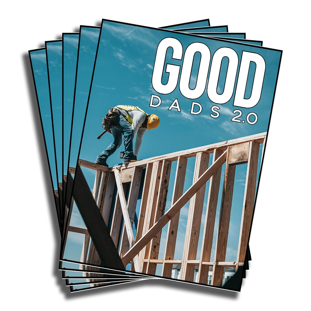 A stack of Good Dads 2.0 program covers, fanned out in a pile.