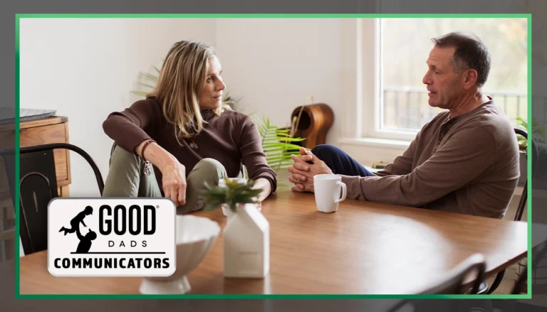 Good Dads Communicators: a middle-aged couple sit at a table, facing each other and conversing over a cup of coffee