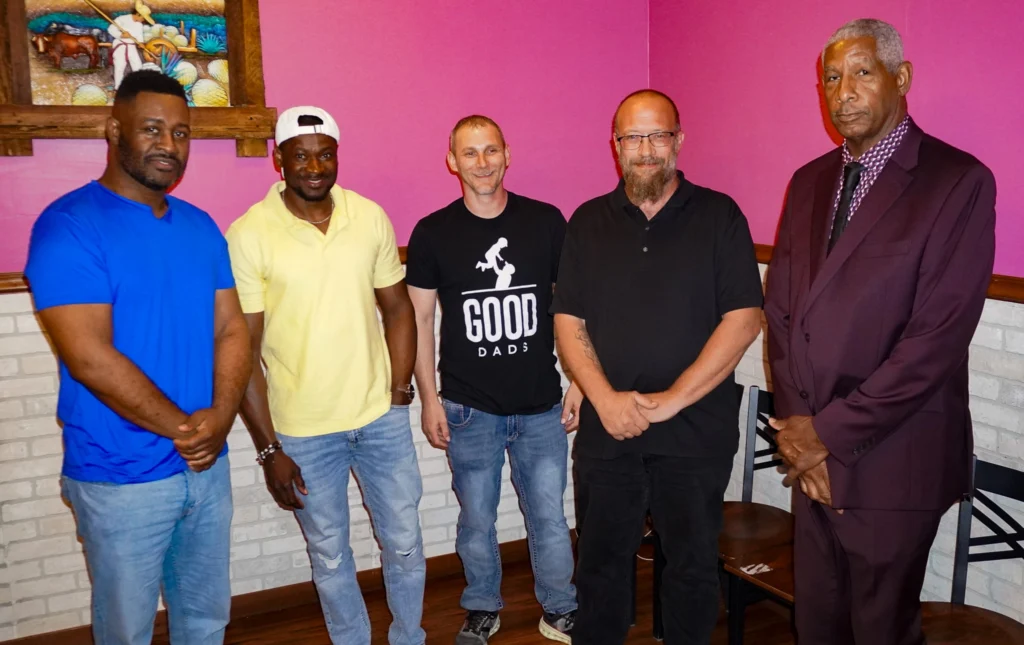 Happy dads stand for a group photo in Fulton, MO, after their last night of Good Dads class in June 2025.