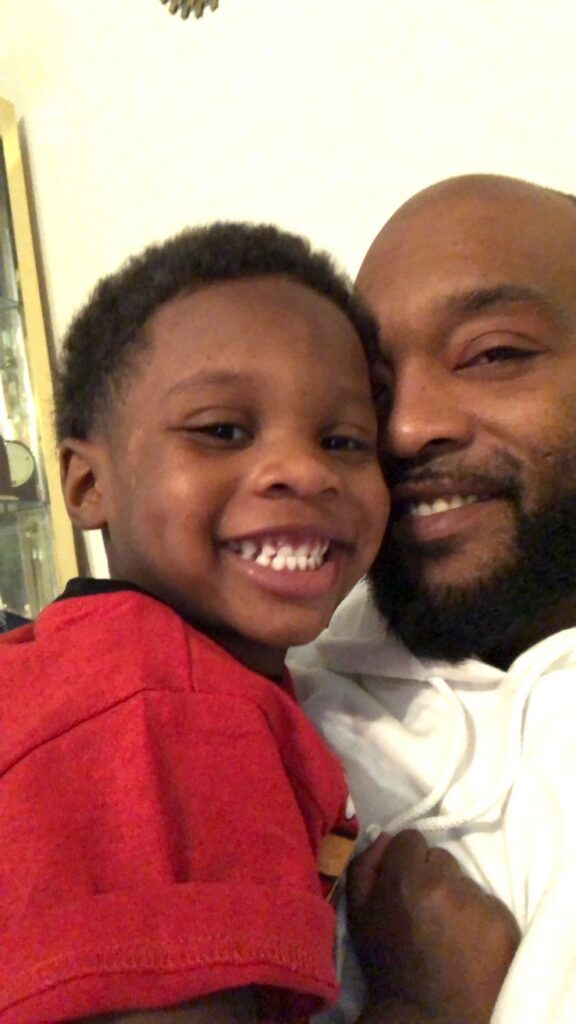 New Pathways graduate Ryan Washington with his child. 