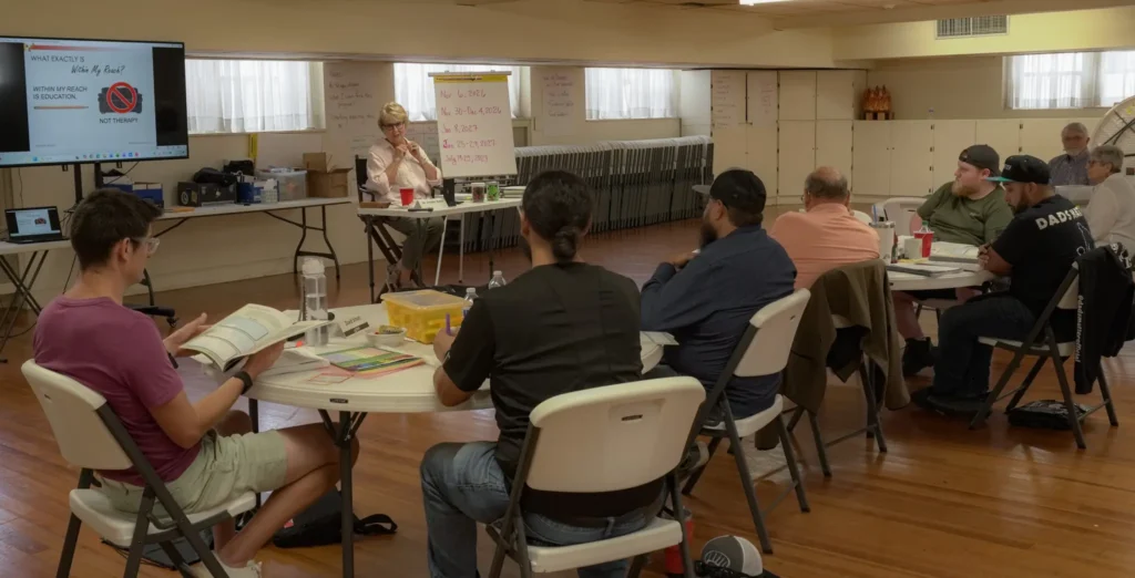 Good Dads' founder and executive director, Dr. Jennifer L. Baker, addresses attending facilitators at the Downtown Church in September 2026 during Training Camp.