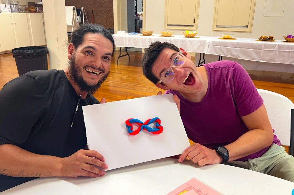 Good Dads facilitators us Play-Doh to construct a sculpture representing the complexity of twenty-first century relationships during a Training Camp activity in September 2026.