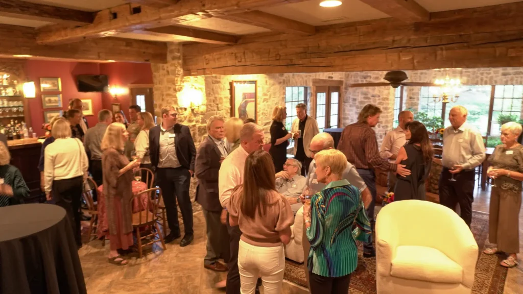 Good Dads supporters and board members mingle at an evening reception to celebrate the nonprofit's outcomes, at the home of a Good Dads board member, in October 2026.
