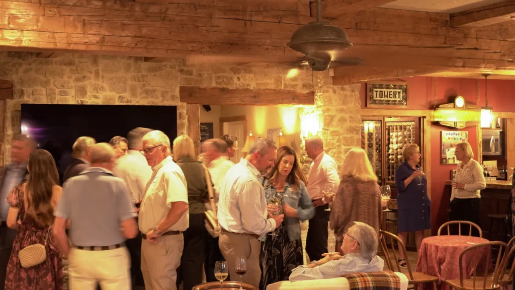 Good Dads supporters and board members mingle at an evening reception to celebrate the nonprofit's outcomes, at the home of a Good Dads board member, in October 2026.