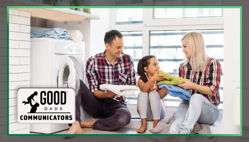 Good Dads Communicators: A father, young girl and mother sit in a laundry room in front of a dryer with a folded pile of laundry.